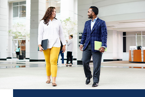 Two Supernus employees walking down the office hallway.